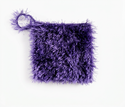 Purple textured loofah scrubber with a hanging loop, laid flat on a white background